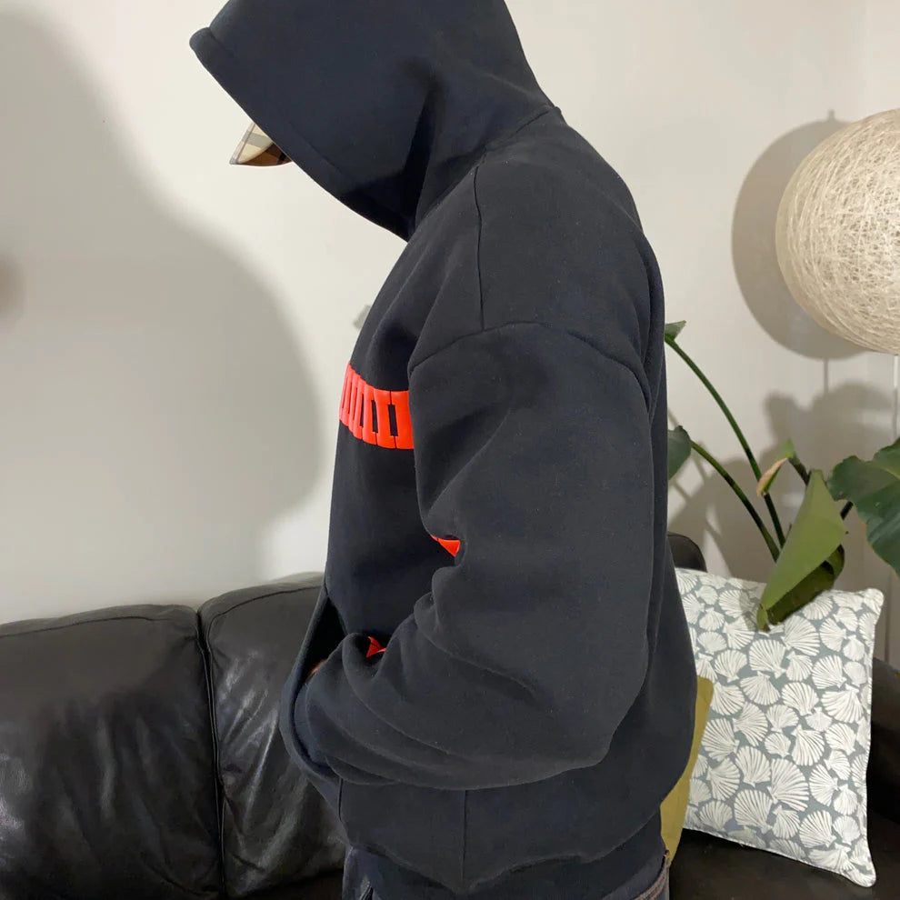 Black “I LOVE YOU THIS MUCH” hoodie laid flat showing oversized fit and premium fabric