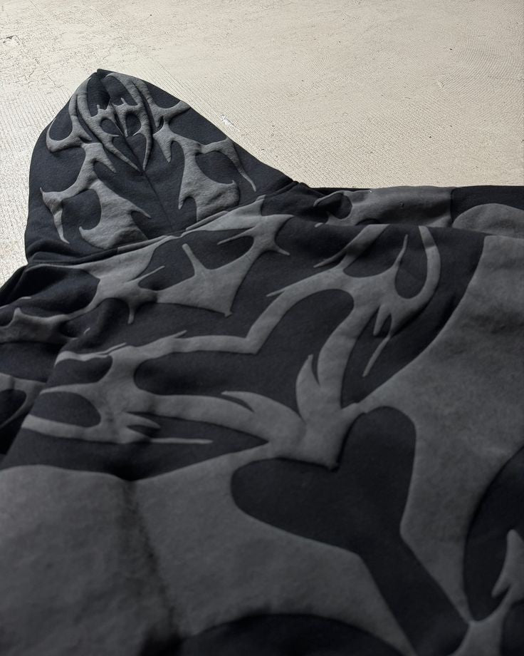 Tribal Shadow Depta Hoodie by Thread Shade – Unisex oversized hoodie featuring all-over puff print, hidden side pockets, and a relaxed fit. Made with 400gsm cotton fleece for ultimate comfort and style.