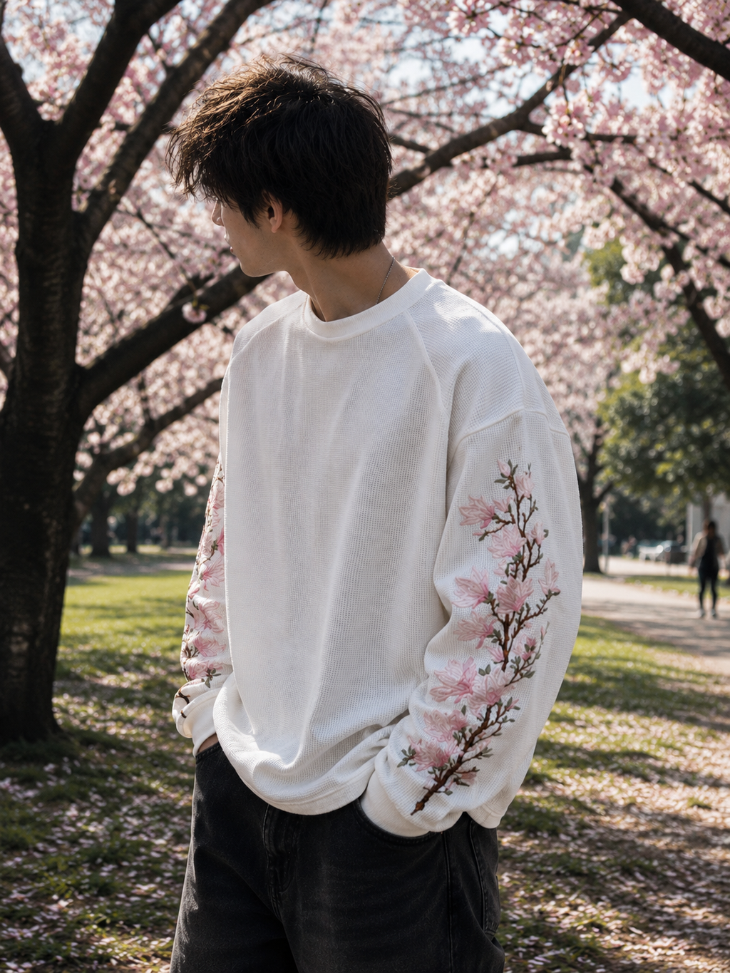 Side profile of model wearing Sakura Drift Waffle Tee showcasing floral embroidery and relaxed silhouette.