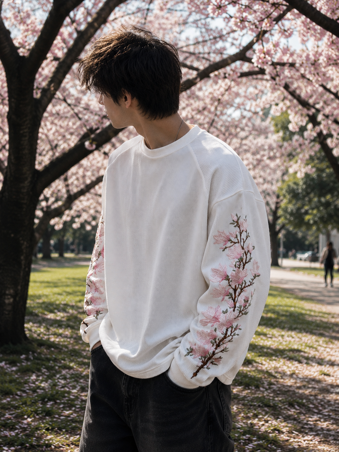 Side profile of model wearing Sakura Drift Waffle Tee showcasing floral embroidery and relaxed silhouette.